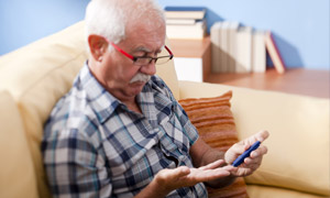 Senior man doing blood sugar test