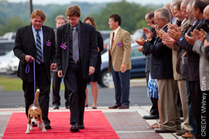 Dogs and owners walking done red carpet at the opening event