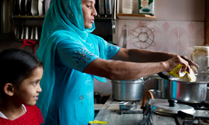 Young girl helps her mother in the kitchen