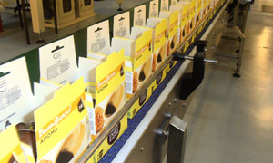 Boxes of Nescafé Dolce Gusto capsules on the factory production line