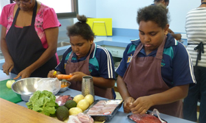 Aboriginal teenagers learning how to cook