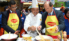 Nandu Nandkishore and Paul Bulcke attending cooking event