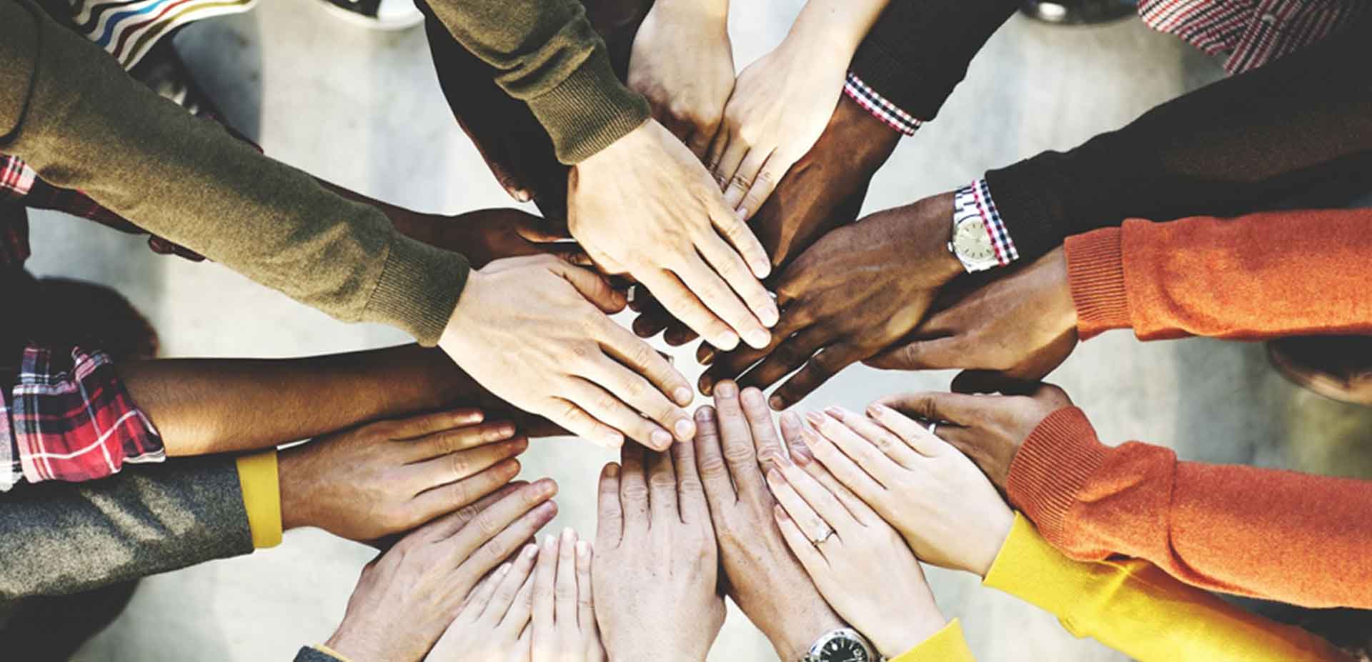Hands of people of different races hold together