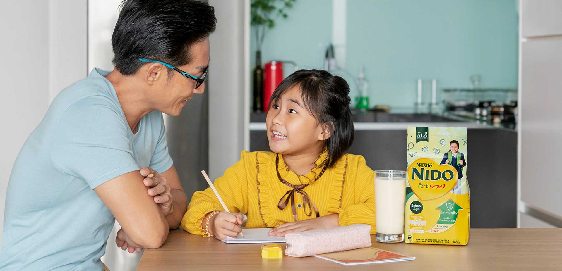 Dad helping daughter with homework and Nido