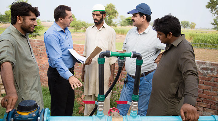 Men's discussion near water tap