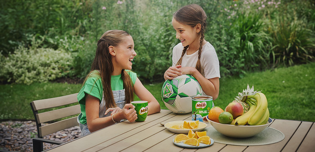 2 girls drinking Milo