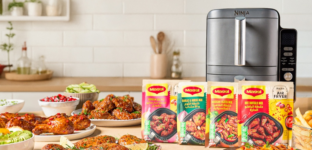 An Airfryer with food and Maggi packages on the table