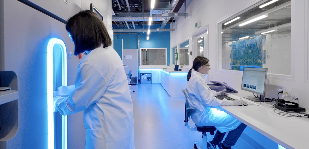 Researchers working in a modern laboratory with advanced equipment and computer analysis stations