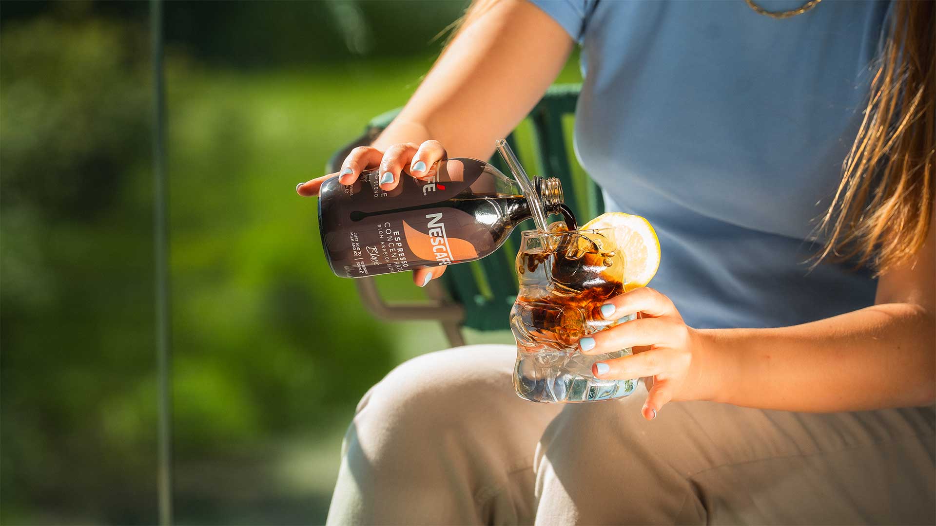 A woman is pouring coffee into a cup