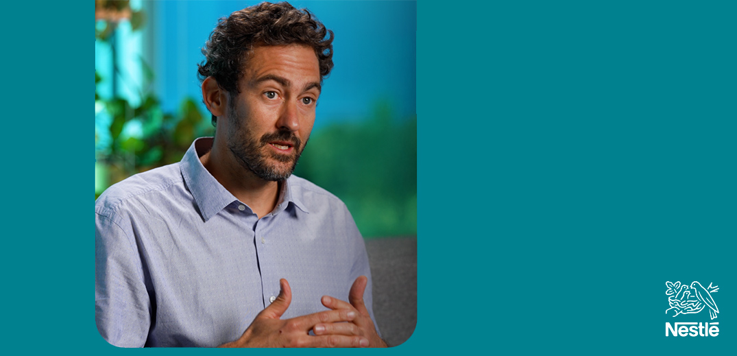 Person speaking during a Nestlé interview against a teal background