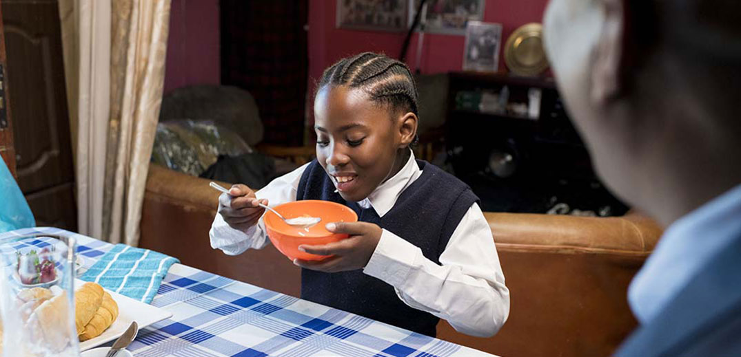 African schoolgirl having a meal
