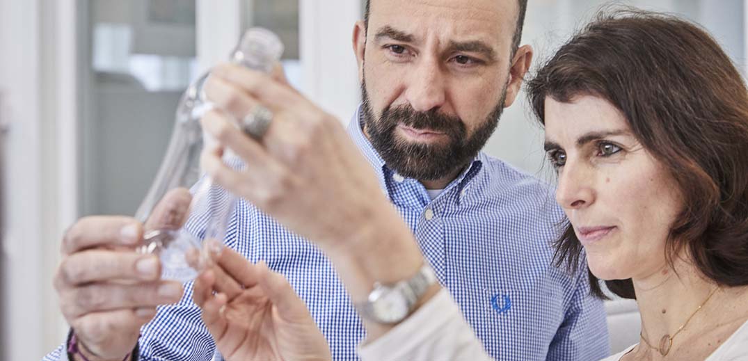 ask-nestle-plastic-packaging-wide Man and woman in lab check plastic bottle