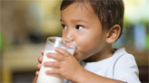 young child drinking milk