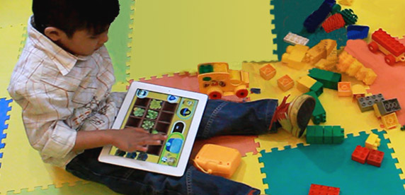 boy playing with the StimuLearn app