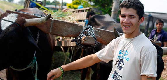 Students at the ‘self-sufficient school’ - Fundación Paraguaya - unloading sugar cane to feed the cattle