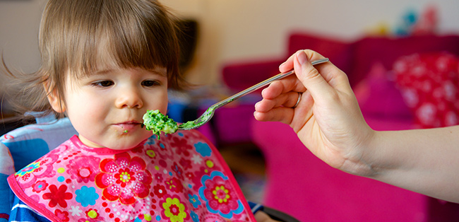 Baby girl eating mashed brocolli baby-girl-eating-mashed-broccoli.jpg