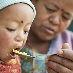 grandmother feeding child grandmother feeding child