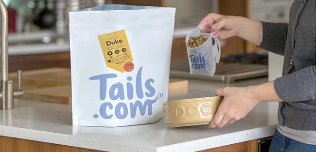 Women filling bowl with dog food personalised-petfood-tails-story.jpg