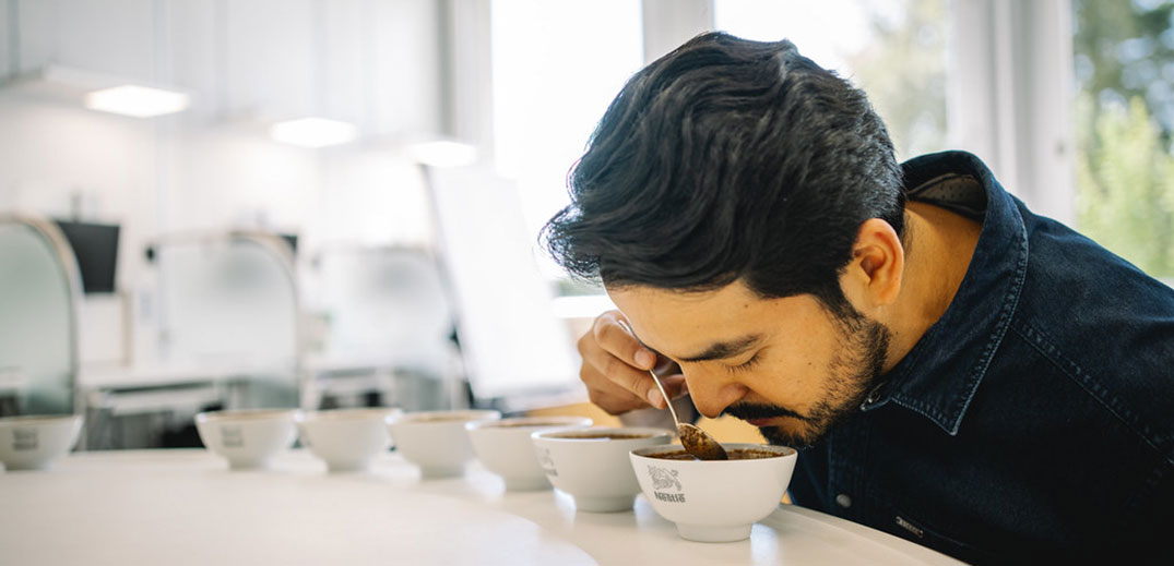 man is tasting coffee
