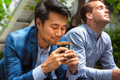 Two young men enjoying coffee break