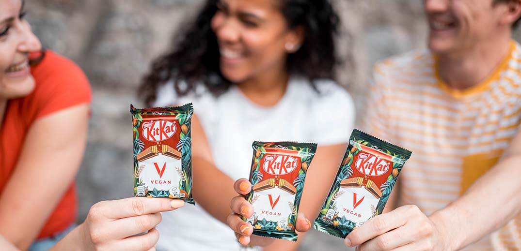 People showing three KitKats Vegan