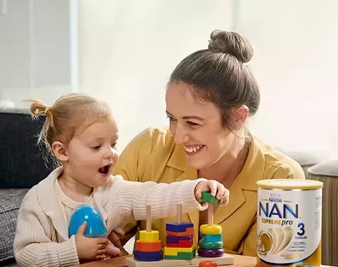 Woman playing with child