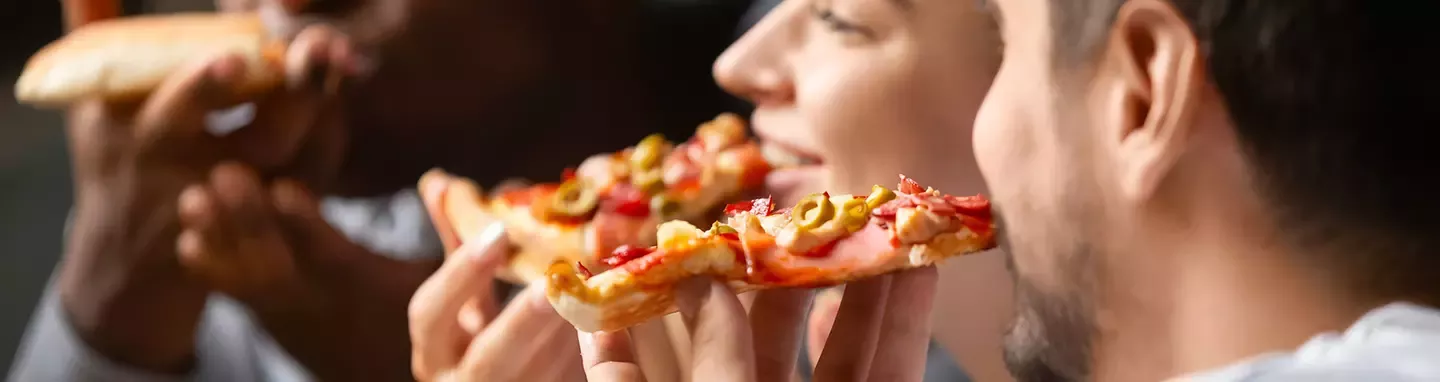 friends sharing slices of a DiGiorno pizza