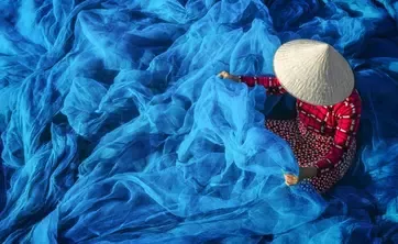 Person in waves of fabric