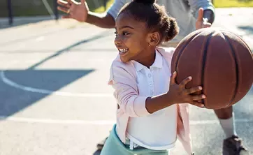 child playing basketball