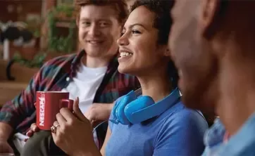 woman holding Nescafe cup