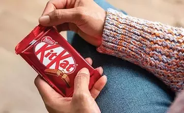 woman holding Kitkat