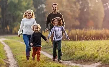 Family with two children walking in the park