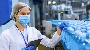 Quality control inspection of bottled water production at a beverage facility