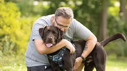 Man hugging his dog