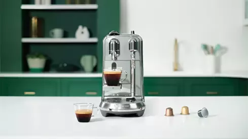Starbucks coffee machine on table and coffee cups