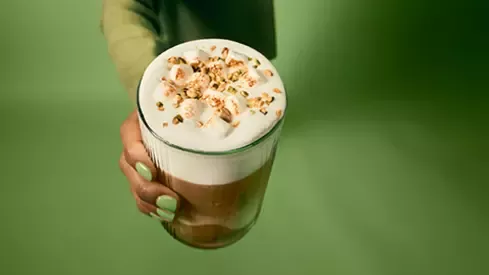 Woman holding a delicious cup of Nespresso coffee