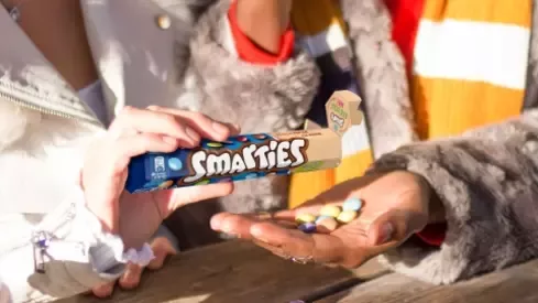 smarties drops falling on the hand
