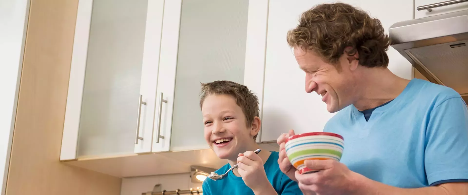 Father and son are eating the cereals