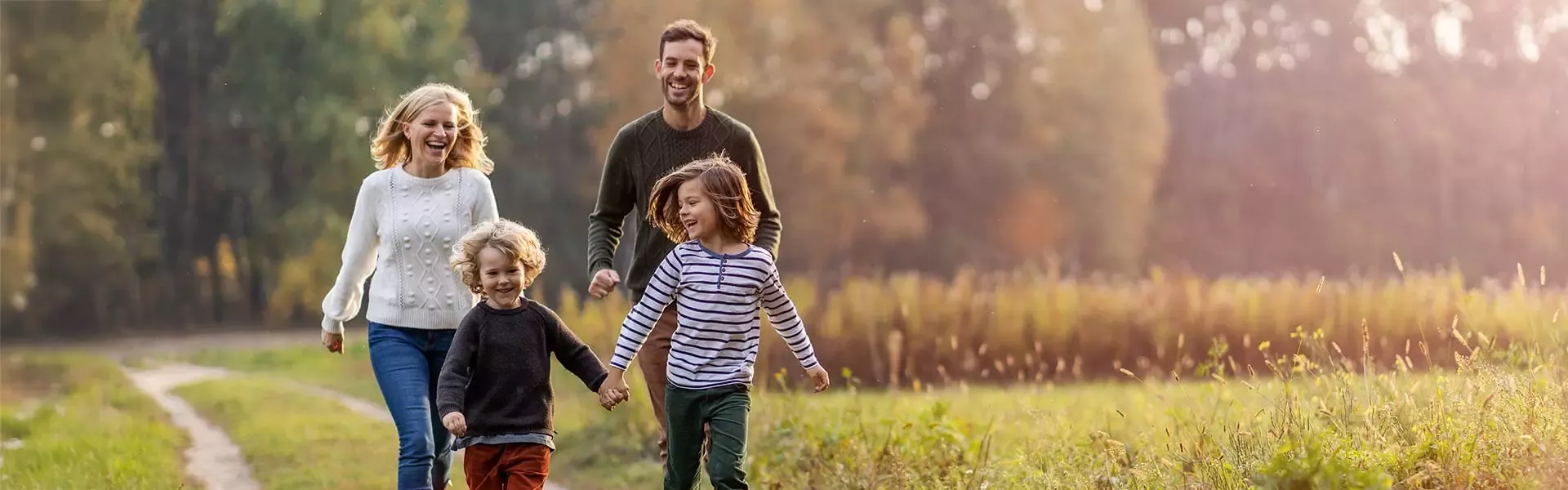 Family with two children walking in the park