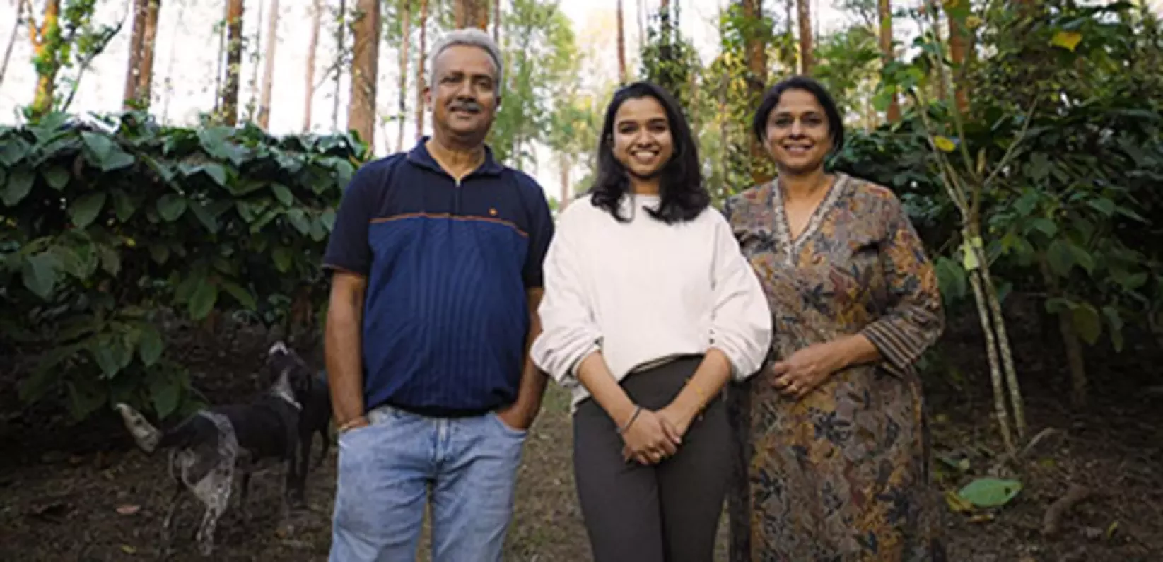 Family with a dog standing in the forest