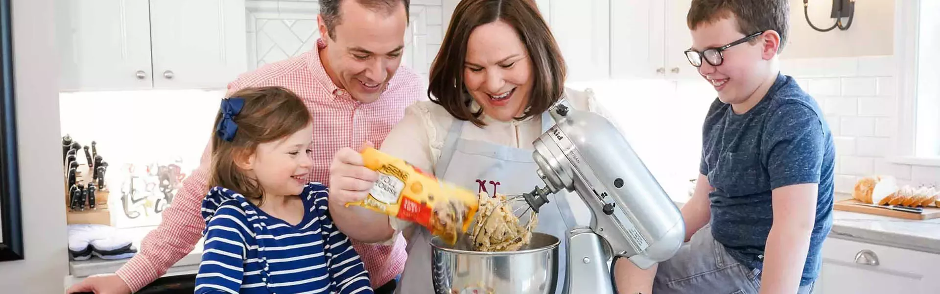 family in the kitchen baking Toll House cookies