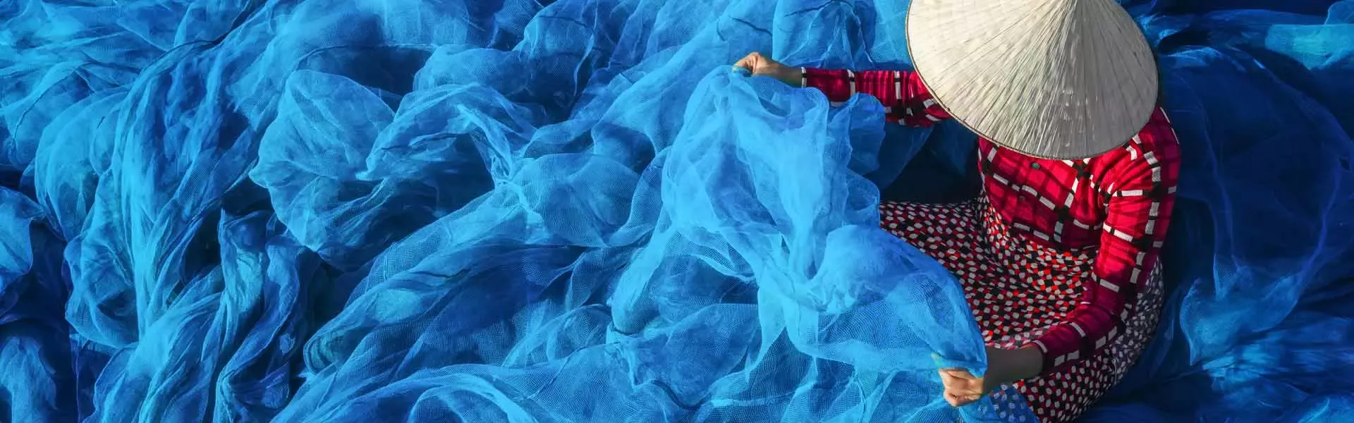 Person sitting in waves of fabric