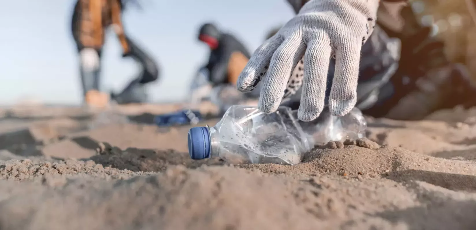 People picking up litter from beach