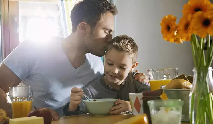 Father and son having breakfast