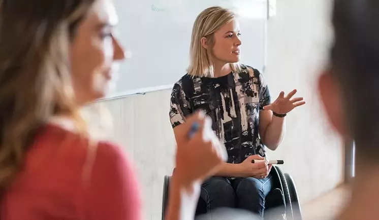 three women chatting in a circle sitting down