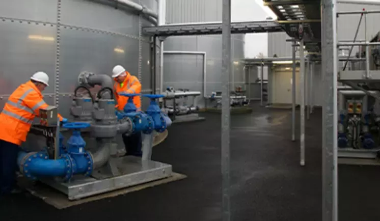 2 people working with pipes