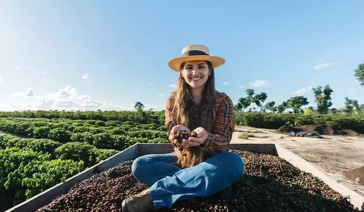 woman holds coffee grapes