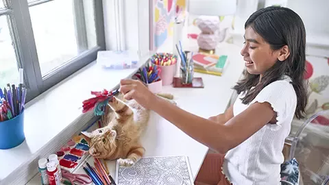 Girl playing with cat