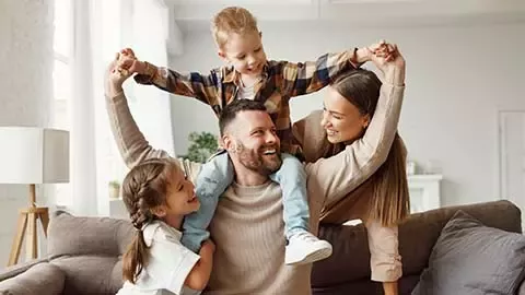 Parents playing with two children