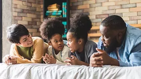 Parents playing with two children